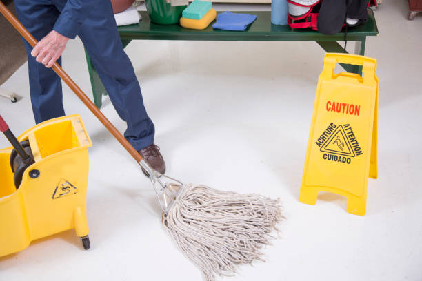 Senior adult Janitor keeps the floors cleaned and sanitized due to the virus
